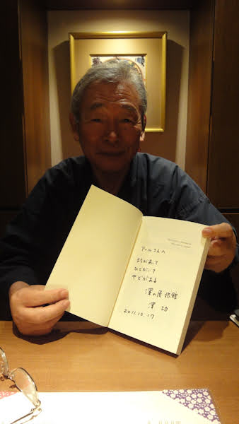 the owner showing his signature in the book